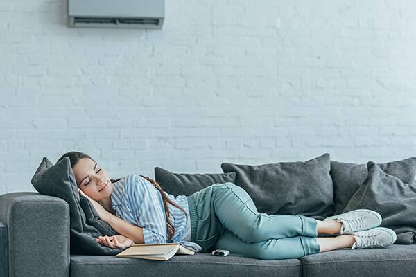 woman lying on the couch of her living room