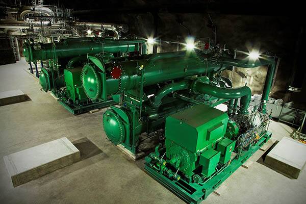 Large industrial district cooling or refrigeration equipment installed inside a utility facility.