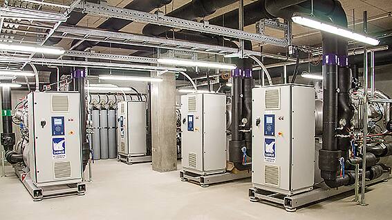 Industrial heat pump equipment installed in a mechanical plant room.