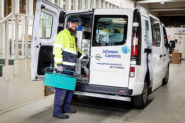Service technician unloading tools from service van